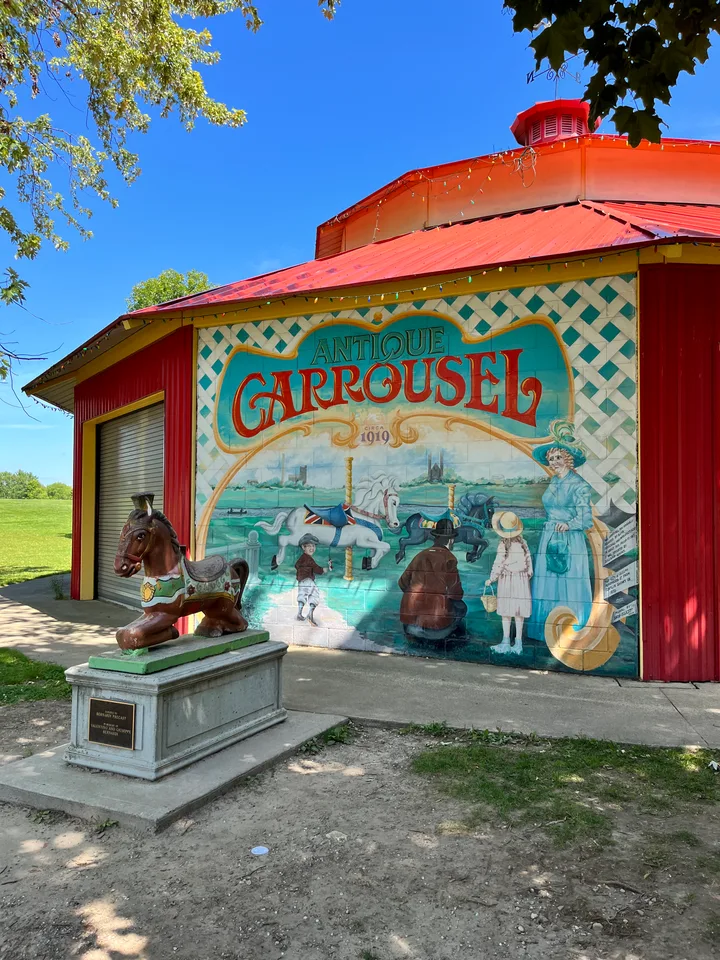Red Riverside Park carousel building and painted mural.